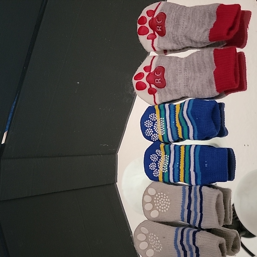 New Puppy or dog socks Never Used.. Sz small and one medium.  Rubber on bottoms.